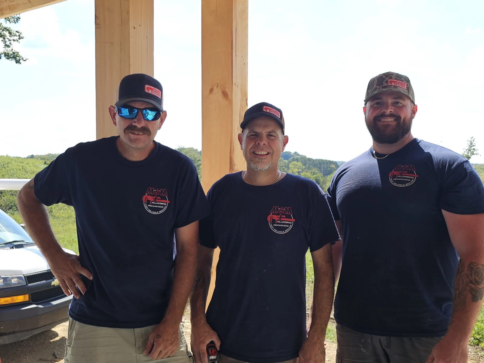 The M&M Plumbing team together at a residential job site